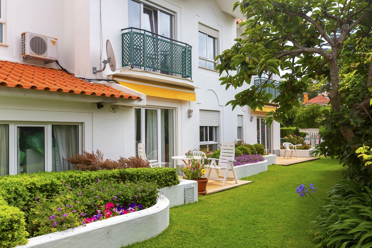 The residence looking onto its flower-filled garden