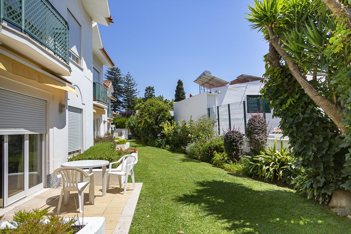 A private patio and garden lawn alongside the residence