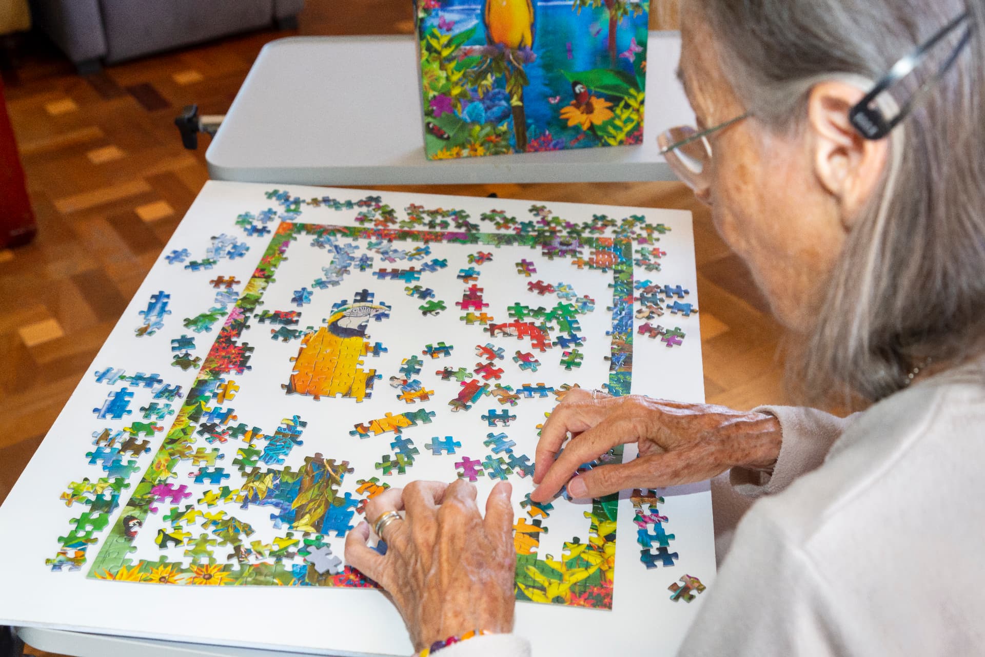 A resident working on a jigsaw puzzle in the lounge
